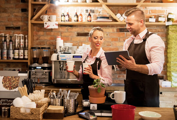 People working in cafe and using tech