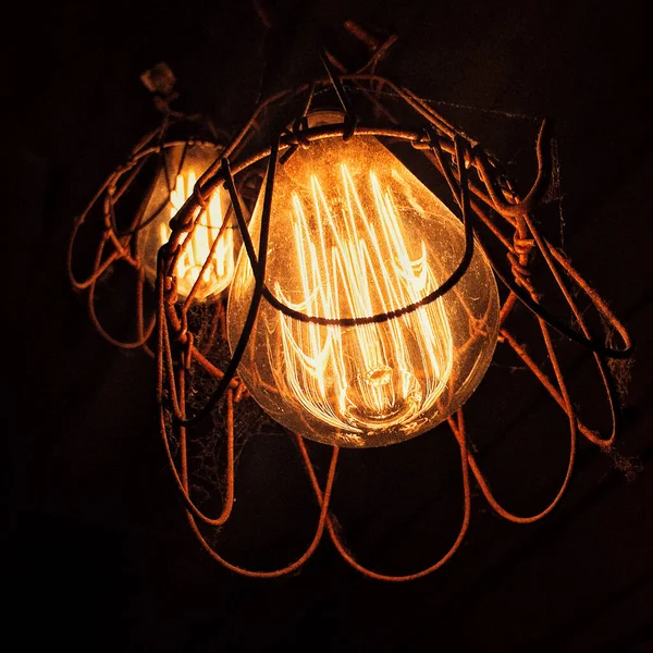 The filament of a light bulbs glowing red hot