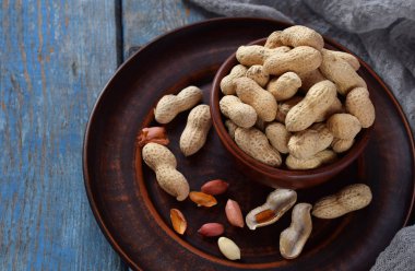 Fındık kabuğu ve ahşap zemin üzerine soyulmuş fıstık fıstık. Diyet ve sağlıklı beslenme. Çiğ gıda