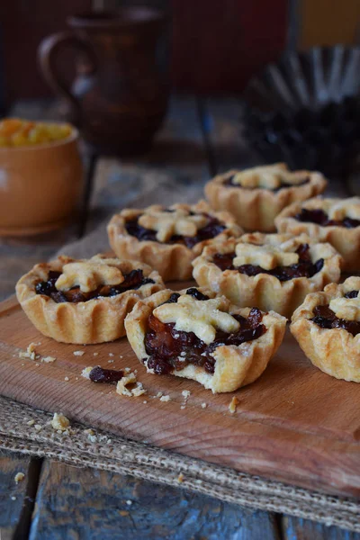 ドライ フルーツとナッツのミニからのタルト 木製の背景に詰め物のフルーツ ショートブレッド クッキー 小さな甘いパイ コピー スペース — ストック写真