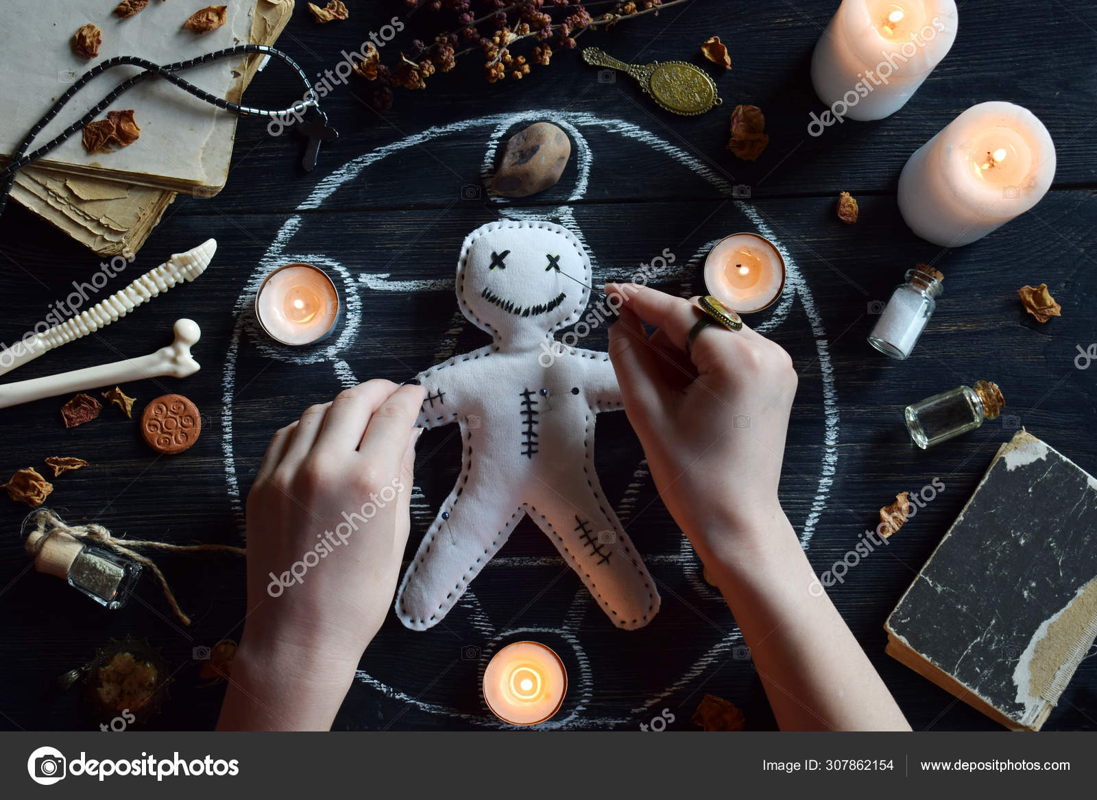 Love Potion Leaning On A Book Of Spells Stock Photo - Download