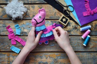 Pembe lama yapıyorum. Kendi ellerinizle keçe den dikiş oyuncaklar. Çocuklar için Diy kavramı. El yapımı el sanatları. Adım 5. Oyuncak süslemek.