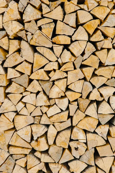 Stacking of round wood. Dry cut wood texture. Timber industry. Woodpile of light color core with cracks. Wood storage place. The structure of dry birch logs. Fuel materials for firewood in the village