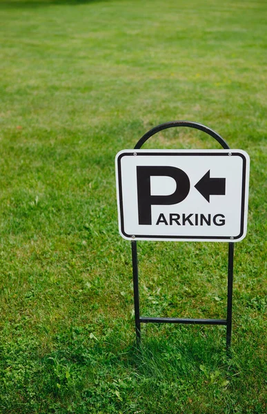 parking sign on green lawn, parking sign