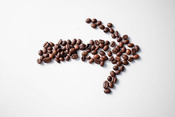 Grains of coffee on a white background. Different shapes made from grains
