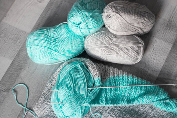 threads and knitting needles, there are skeins of different threads nearby