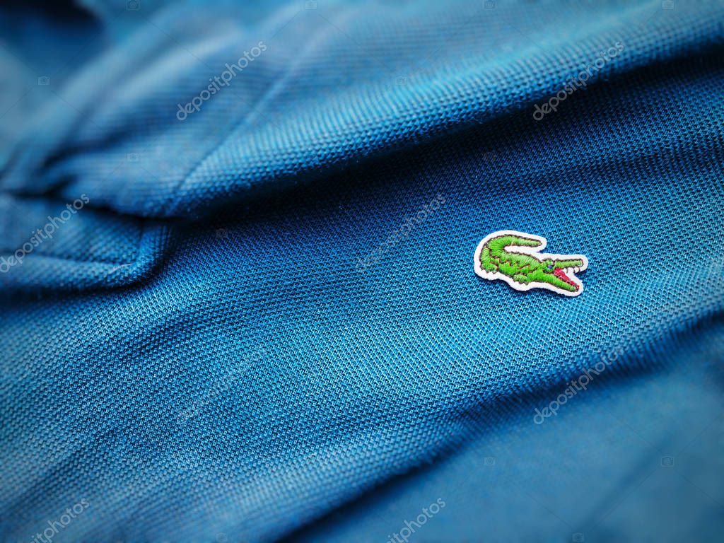 Rome, Italy, august 3rd 2018: close up view of a Lacoste blue shirt. Focus on the sewn crocodile