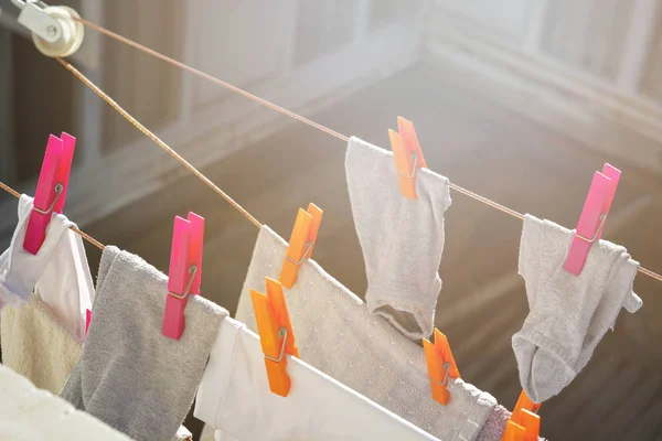 Laundry hanging on clothes line to dry at the sunlight