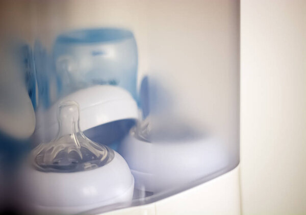 teats and baby bottles inside a steam sterilizer. Equipment for newborn babies