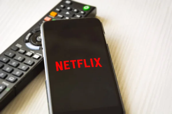 stock image Mobile phone with the Netflix logo screen