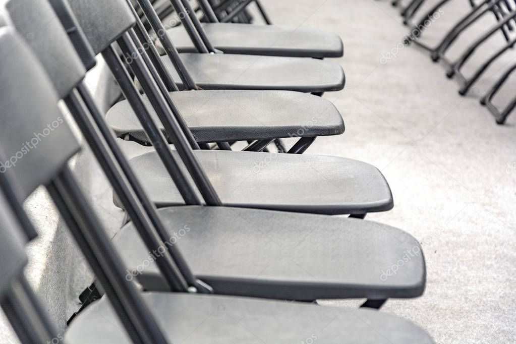 Rows of black folding chairs