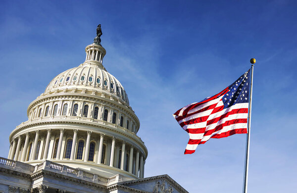 American flag waving with the Capitol Hill