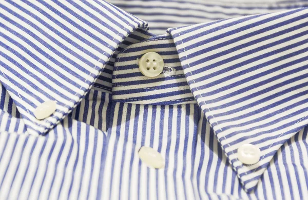 A blue striped shirt with a button down collar. Formal wear for events or work and business meetings