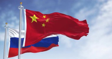 The flags of China and Russia waving in the wind on a clear day. International relations and diplomacy. Seamless 3d render animation. Slow motion loop. Selective focus