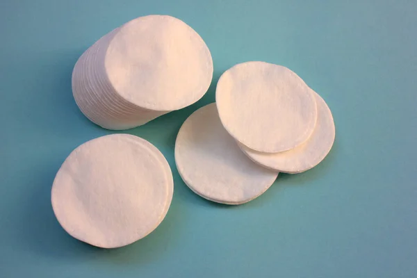 Cosmetic product Cotton pads for skincare on blue background with copy space. Top view, selective focus