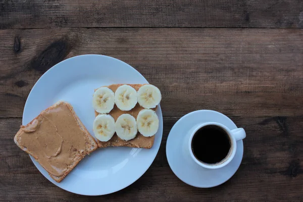 Taza Café Tostadas Plátano Con Mantequilla Maní Sobre Fondo Madera — Foto de Stock