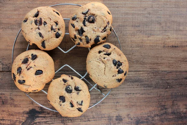 Fresh baked chocolate chip cookies on wooden background. View from above of Christmas cookies on wood table.