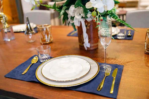 Beautifully laid tables with glasses and appliances at morning in restaurant.