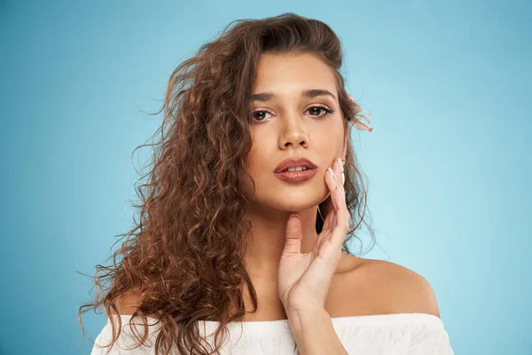 Attractive female model with flower behind ear.