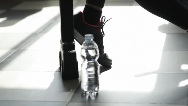 Woman at the gym having a break and drinking water — Stock Video
