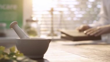 Laboratuvarda çalışan ve bitkisel ilaç, harç ve havaneli ön tarih üzerine bir kitap okuma profesyonel eczacı