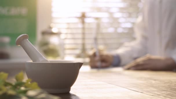 Herbalist Writing Prescription Medicine Working Pestle Mortar Foreground — Stock Video