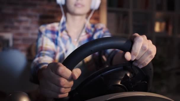 Woman Playing Car Race Video Games Using Racing Steering Wheel — Stock Video