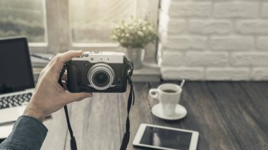 Ev masa başında oturan ve bir selfie kamerası ile bakış açısı ateş alarak hipster fotoğrafçı