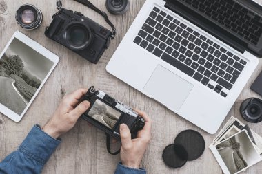 Profesyonel Fotoğraf Ekipmanları, tablet ve laptop üstünde a okul sırası, bir fotoğrafçı fotoğraf makinesi ekranda resim önizlemeleri denetliyor
