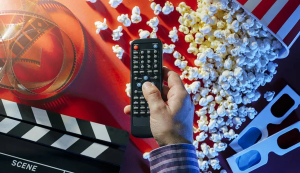 Hand Holding Television Remote Control Popcorn Filmstrip Glasses Clapper Background — Stock Photo, Image