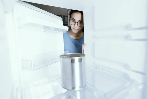 Sad woman looking into her empty fridge — Stock Photo, Image