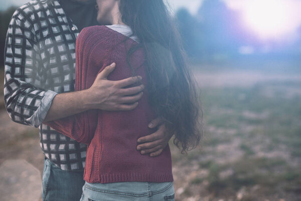 Young loving couple hugging outdoors