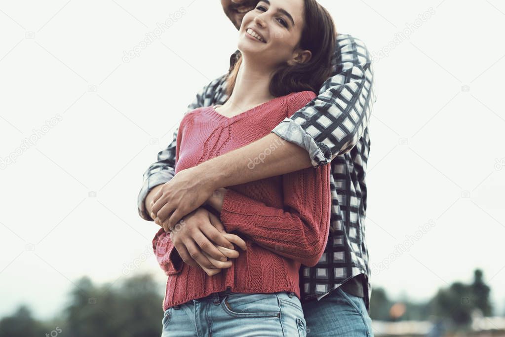 Happy young couple hugging and smiling