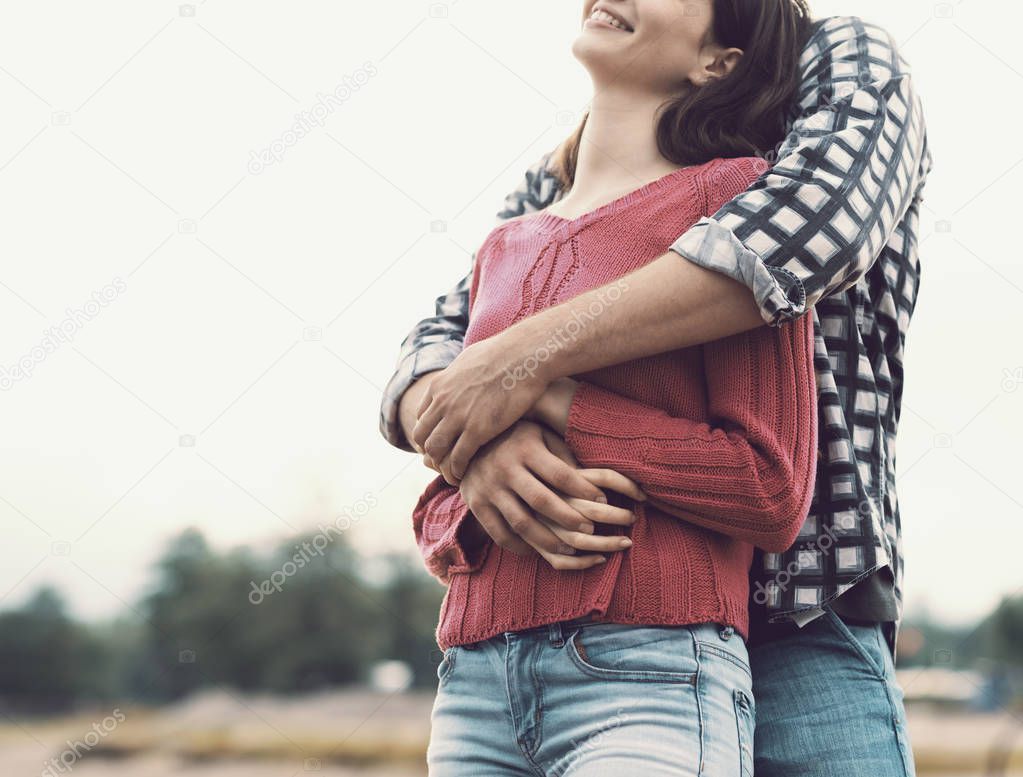 Happy young couple hugging and smiling