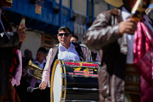 Passionate band performers fill the streets of Paucartambo with powerful melodies during the Virgen del Carmen celebrations, blending devotion, tradition, and vibrant festivity