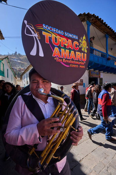 Passionate band performers fill the streets of Paucartambo with powerful melodies during the Virgen del Carmen celebrations, blending devotion, tradition, and vibrant festivity