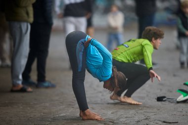 Fırtınadan önce odaklanın ve dengeyi sağlayın. Bir sörfçü kıyıya doğru uzanıyor, vücudu ve zihni La Herradura 'nın güçlü dalgalarına hazırlıyor. Chorrillos Peru.