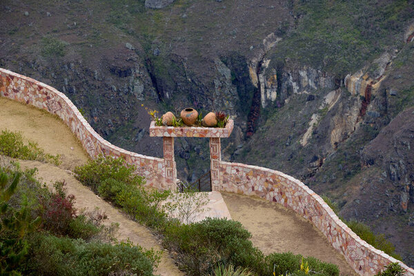 Traditional clay vessels at the Mirador of Huancas beautifully frame the breathtaking canyon landscape, blending culture with nature.