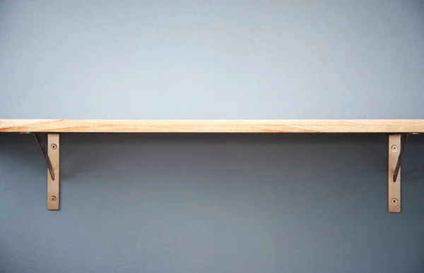 single wood shelf on gray blue concrete interior wall room in cozy home background