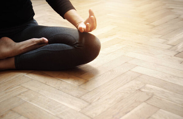 adult woman in yoga meditation relaxation post sport on the old wood floor room background