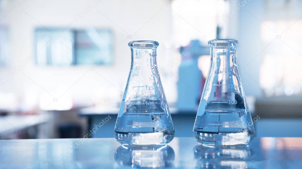 two glass flask with water in chemical science laboratory educat
