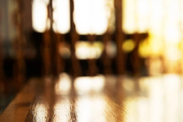 La parte superior de la mesa de madera en el restaurante con ventana de luz solar backgr —  Fotos de Stock