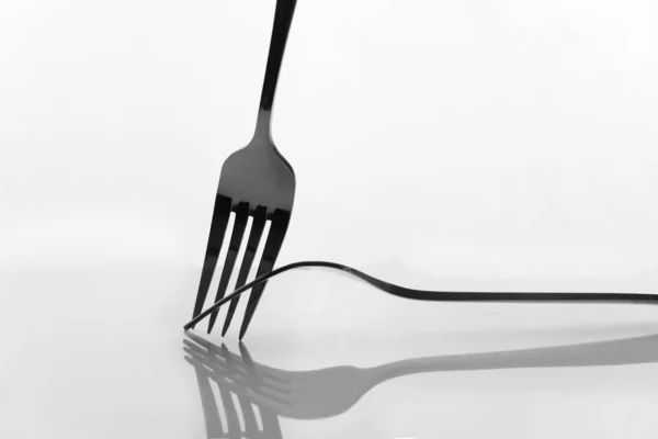 Two metal stainless steel fork interaction still life reflection — Stock Photo, Image