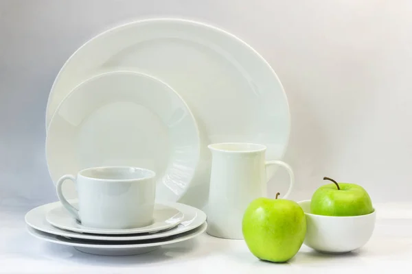 Set of white dishes on a white background