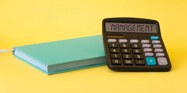 Work equipment - notebook, calculator with the name of the text FINANCIAL ADVICE, on a yellow background. Financial career concept