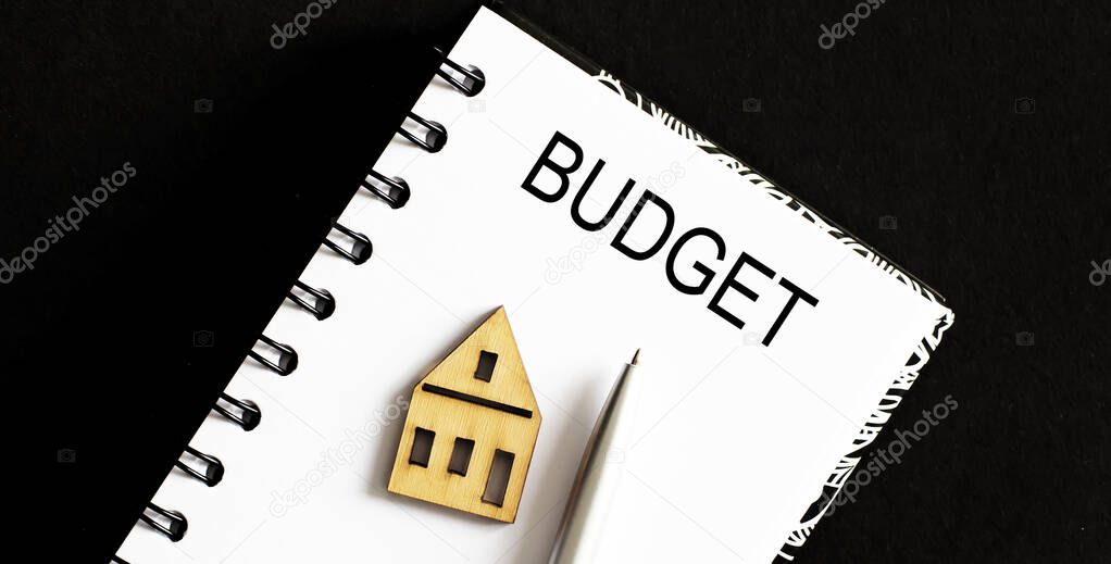 Business Words on notepad, business tex Budget with small house