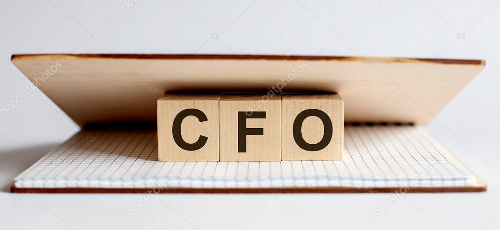 Innovation word wood block CFO on table for business concept.