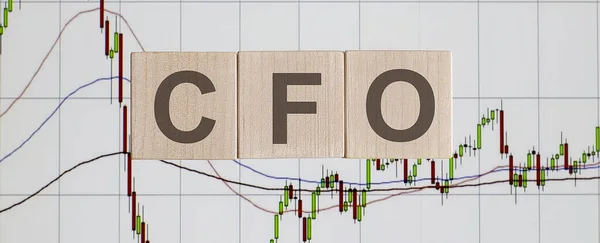 Business Concept with wooden blocks. Text CFO on the chart background