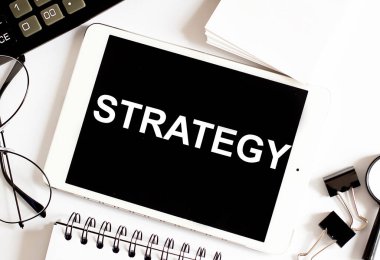 STRATEGY İş Konsepti ofis araçlarıyla beyaz arkaplan üzerine.