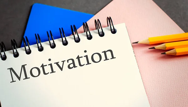 MOTIVATION text in office notebook with office tools